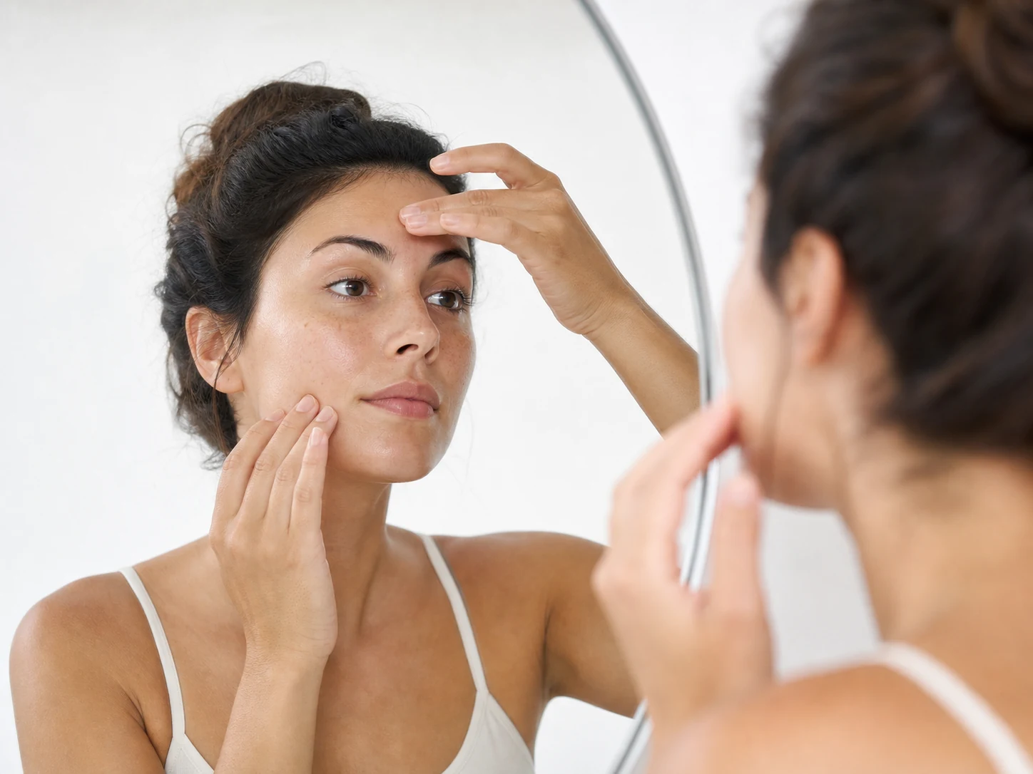 Natural-finish foundation bottle beside combination skin texture
